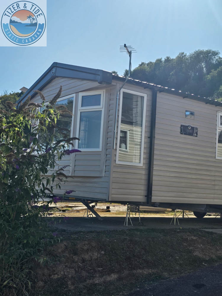 Front corner of the caravan behind a low hedge