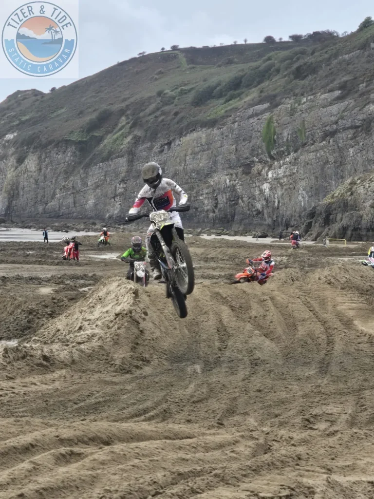 Rider taking a jump on the beach motocross track at Pendine