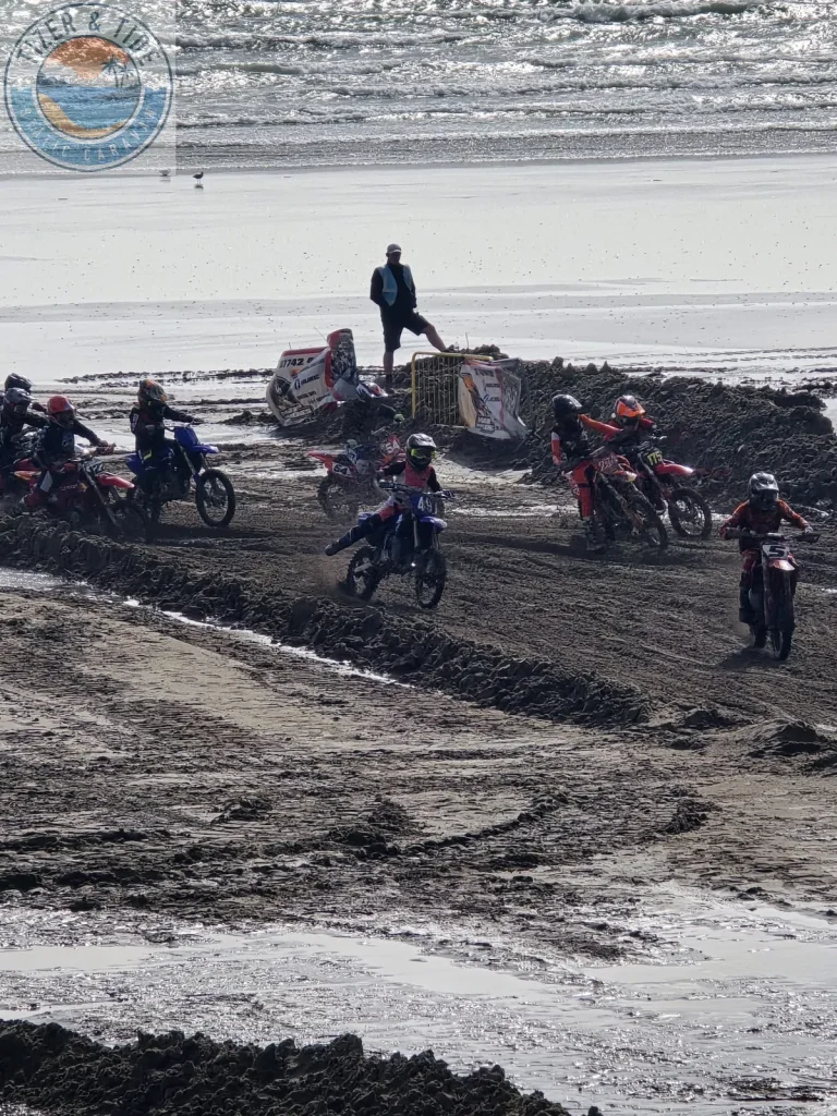 A pack of riders racing on the wet sand at Pendine